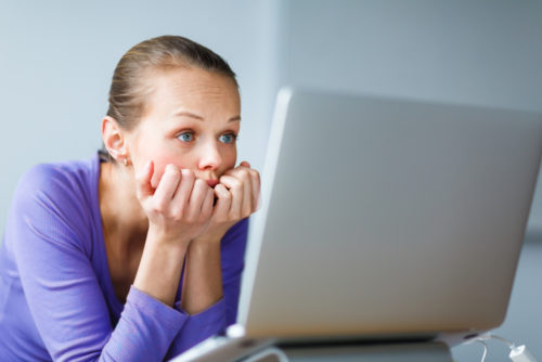 Young Woman Staring Blankly at Computer Screen