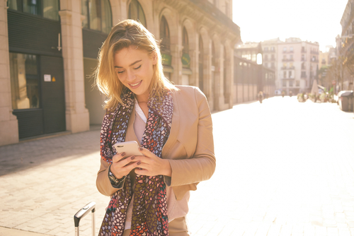 Smiling Young Woman Using Phone