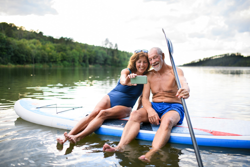 older couple on paddle board